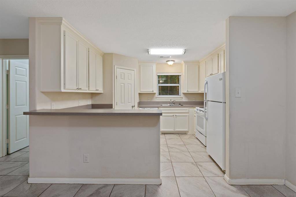 The kitchen boasts modern appliances, ample counter space, and a functional design that caters to both everyday living and hosting guests.