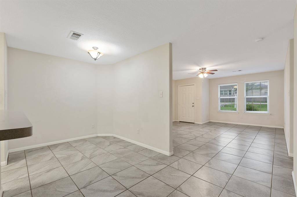 Adjacent to the kitchen, the dining area offers a cozy space for family meals and gatherings.