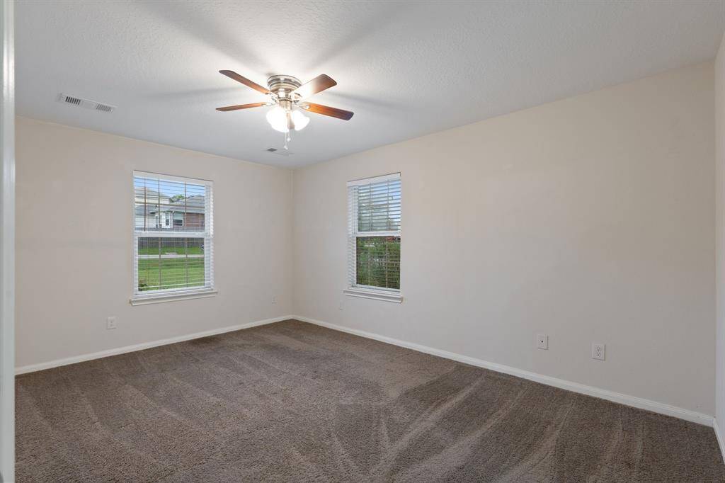 The primary bedroom provides a serene retreat with generous space and comfort