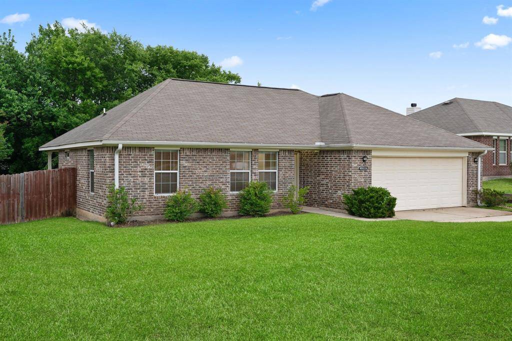 The home's charming façade and manicured landscaping create an inviting first impression.