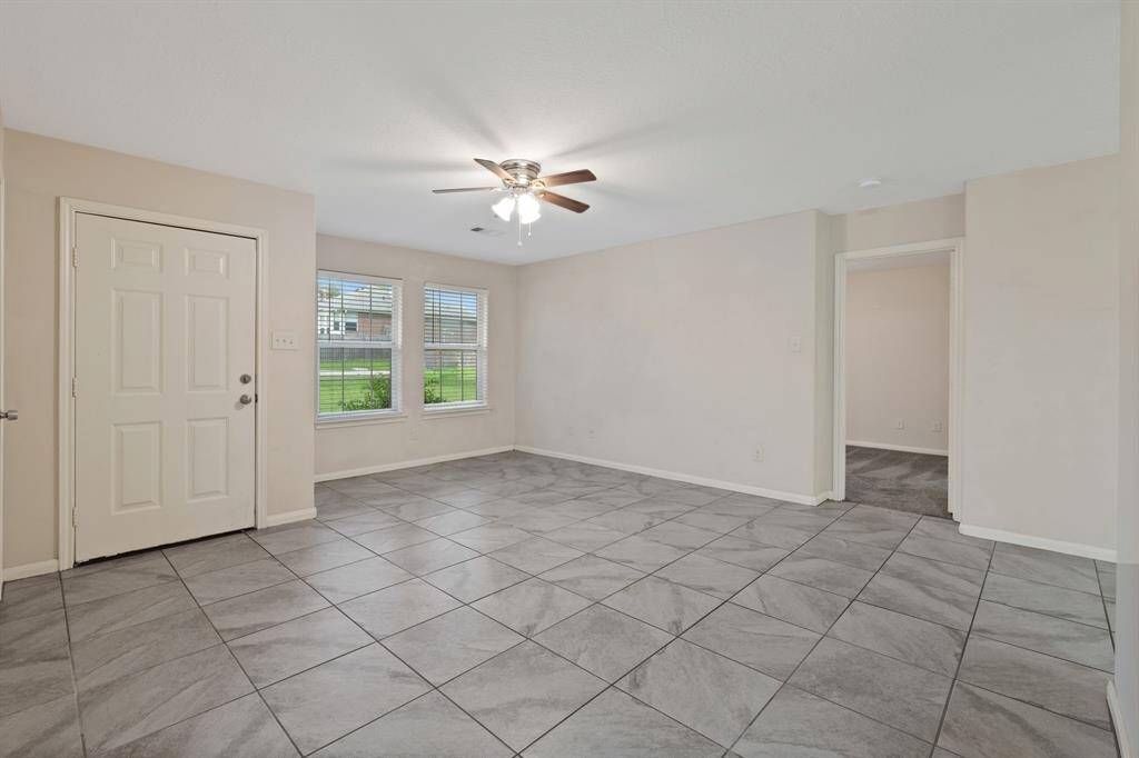 Step into the spacious living area, featuring abundant natural light and a comfortable layout perfect for relaxation and entertaining.