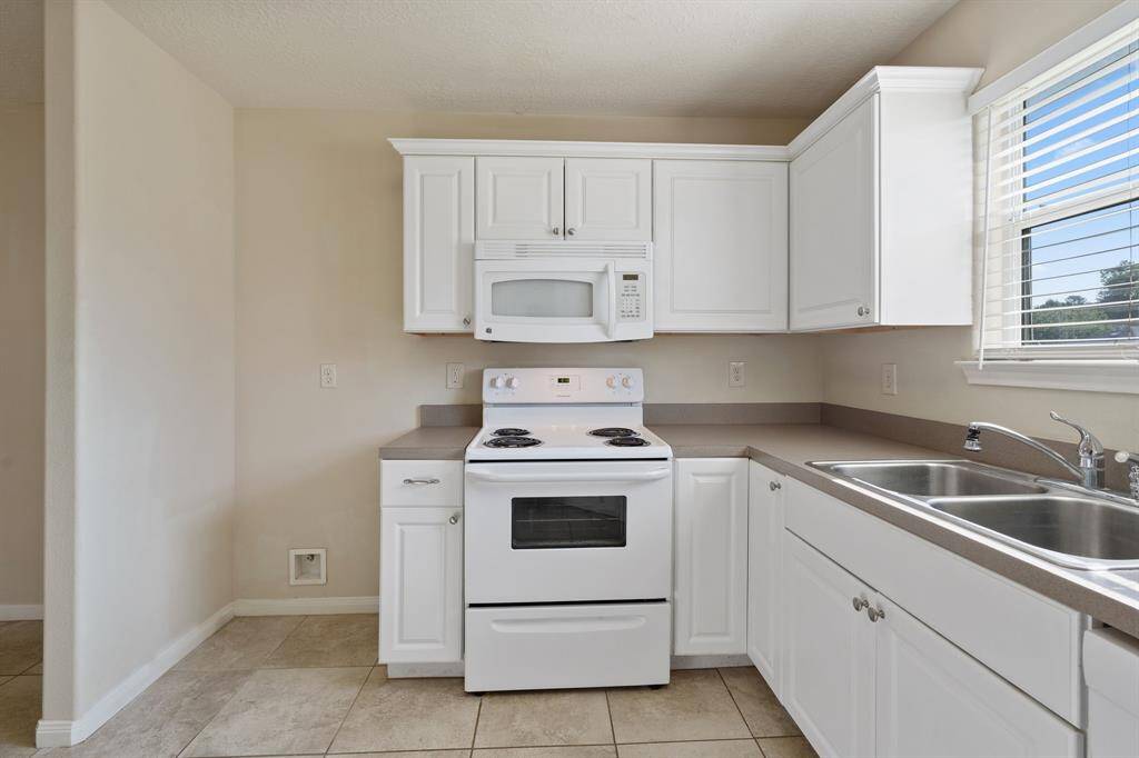 The kitchen boasts modern appliances, generous counter space, and a functional design that caters to both everyday living and hosting guests.