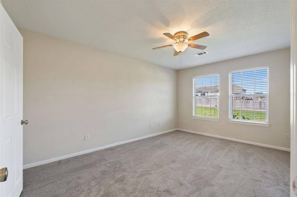 The primary bedroom provides a serene retreat with ample space and comfort.
