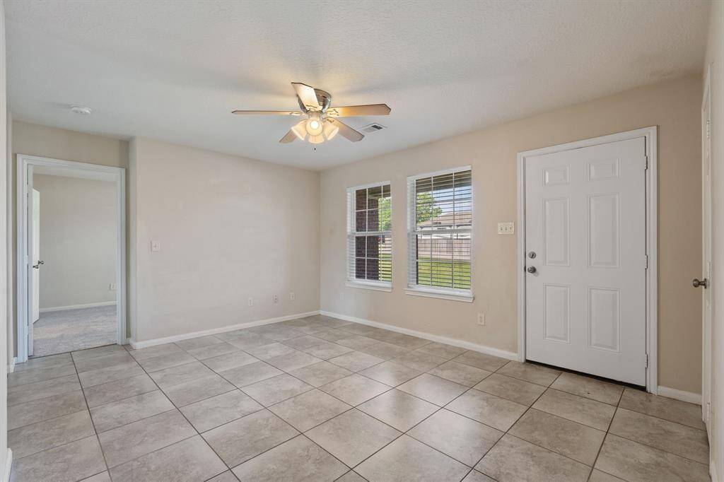 Step into the spacious living area, featuring ample natural light and a comfortable layout perfect for relaxation and entertaining.