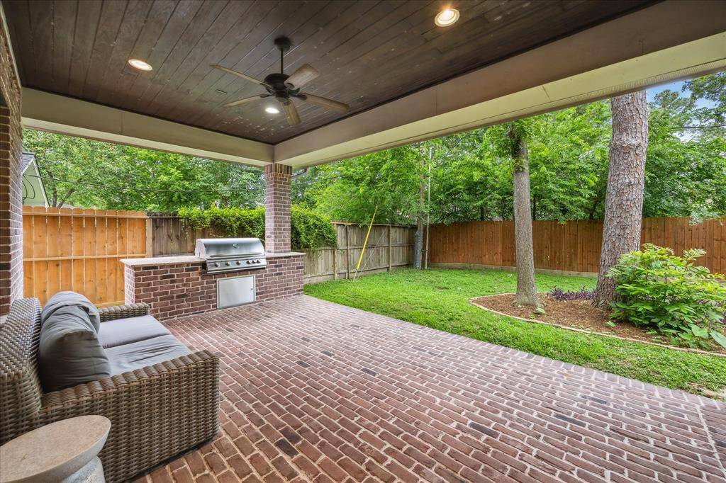 Step outside to a covered back patio complete with a built-in grill—perfect for outdoor dining and year-round entertaining.