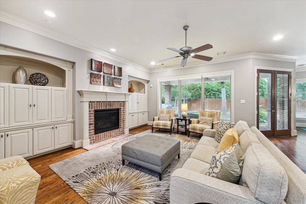 The light and bright living room overlooks the backyard, creating a serene space. Throughout the home, double crown molding adds an elegant touch to every room.