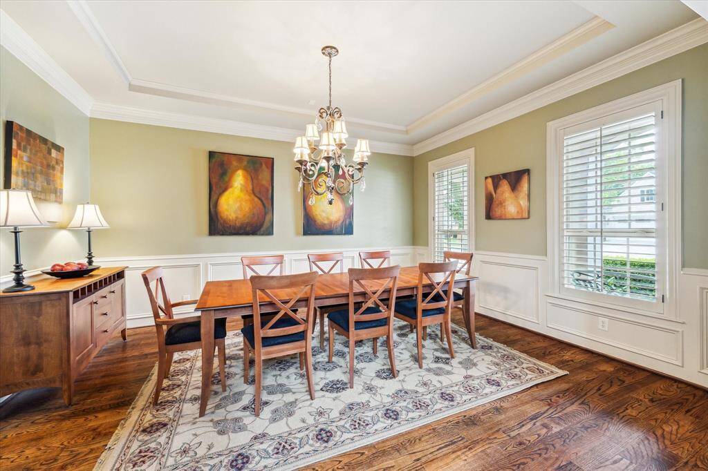 The formal dining room features a tray ceiling, crown molding, and elegant decorative wall molding, offering a sophisticated space perfect for hosting holiday dinners and special occasions.