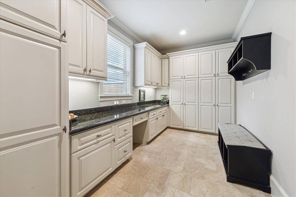 The mud room includes a convenient desk area and extensive storage, perfect for keeping the home tidy.
