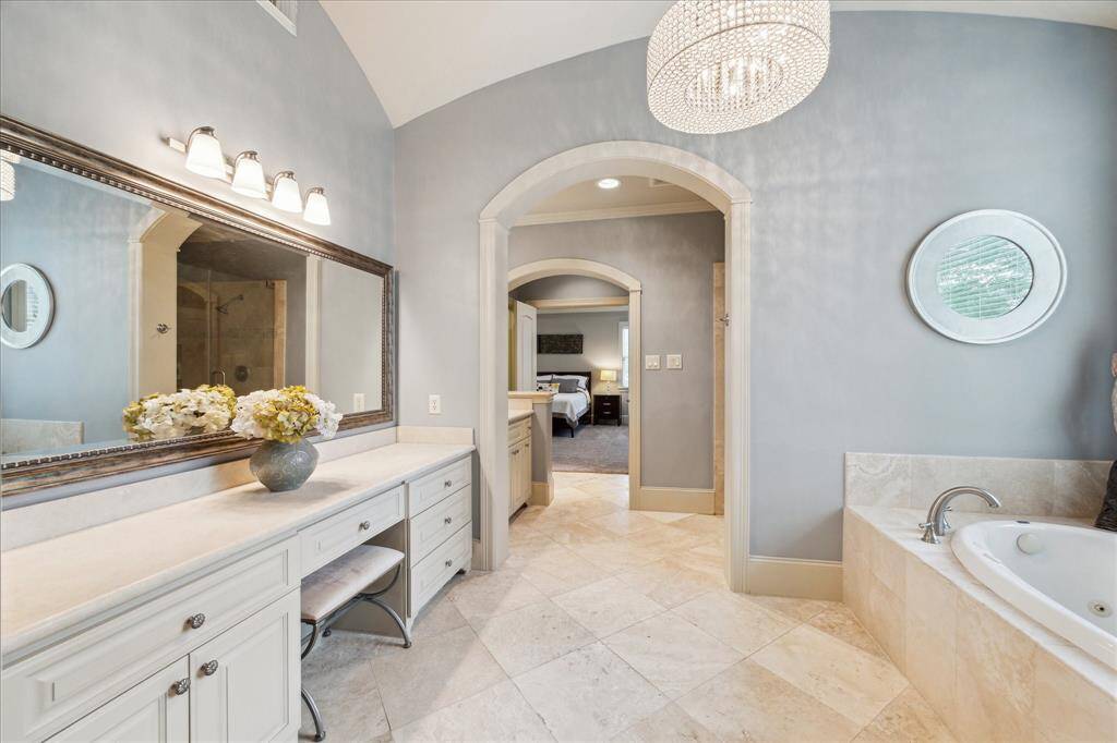 The primary bath offers a spacious vanity area, perfect for all your beauty needs!