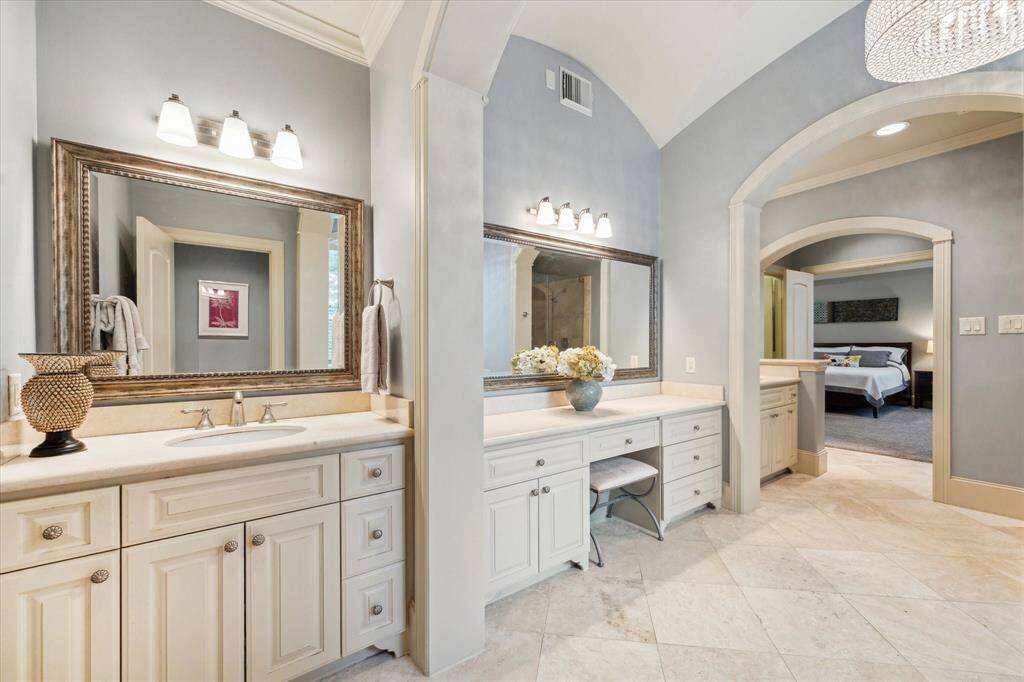 The primary bath features dual vanities and granite counters.