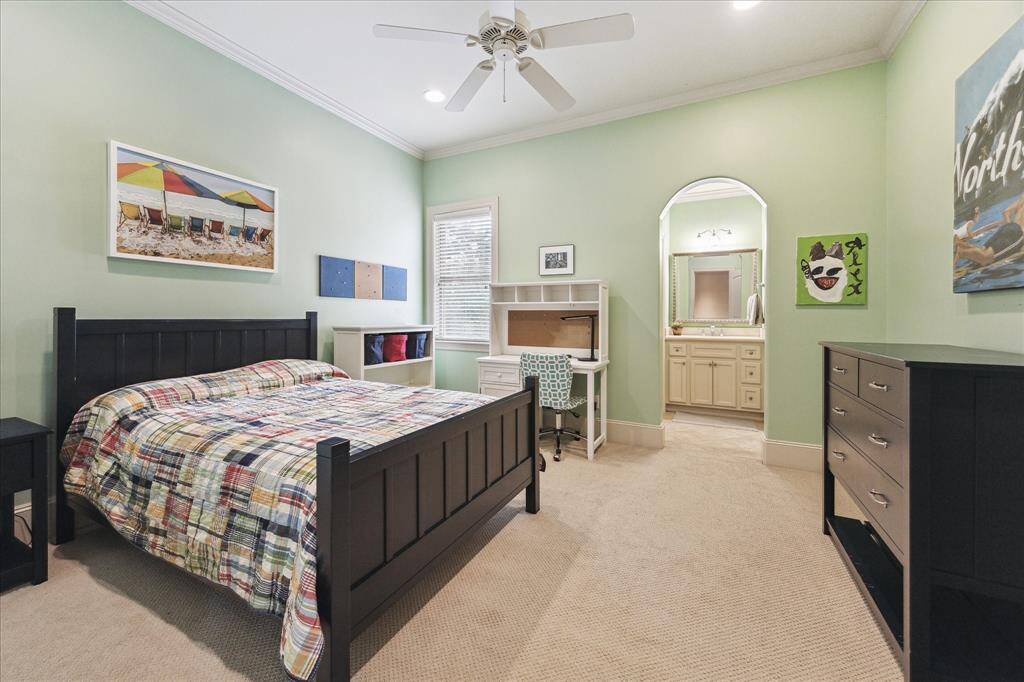 This secondary bedroom includes a walk-in closet and its own vanity sink.