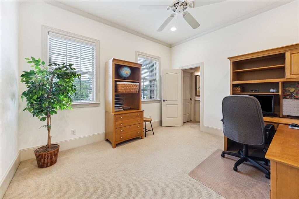 This secondary bedroom, currently set up as an office, boasts an ensuite bath and a walk-in closet.