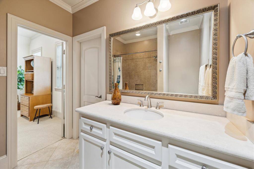 The ensuite bath features a tub-shower combo and a large vanity.