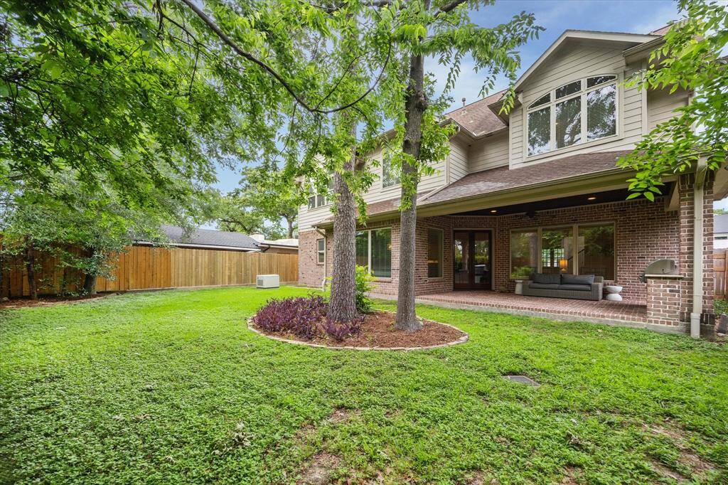 The backyard is equipped with French drains and a sprinkler system, ensuring effortless lawn maintenance.