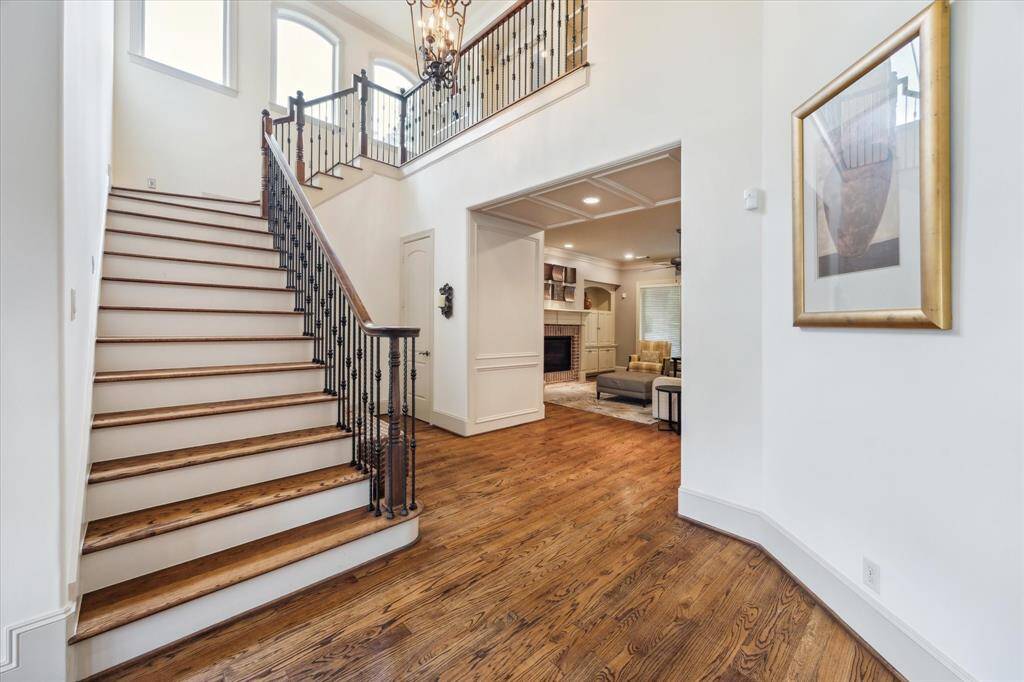 The elegant two-story foyer creates a grand first impression, with soaring ceilings and beautiful architectural details.