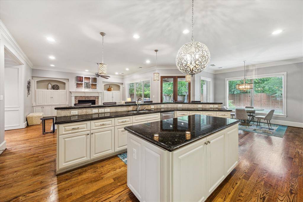 The open-concept layout seamlessly connects the kitchen, living room, and breakfast area, all overlooking the  backyard.