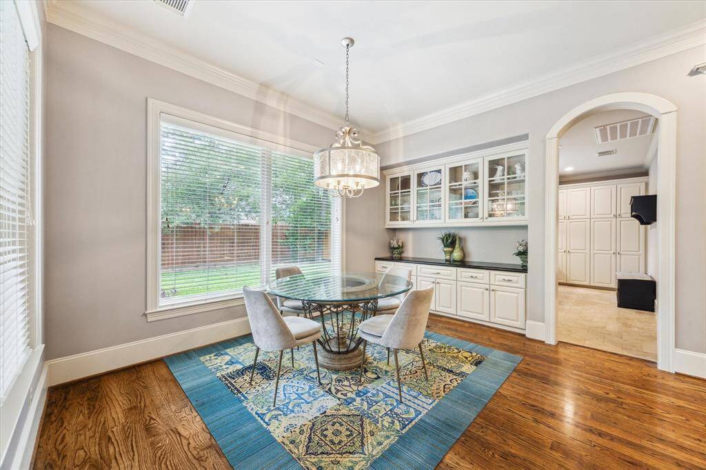 The breakfast room offers additional storage with custom cabinetry, including elegant upper glass-front cabinets for displaying your favorite dishes or decor.