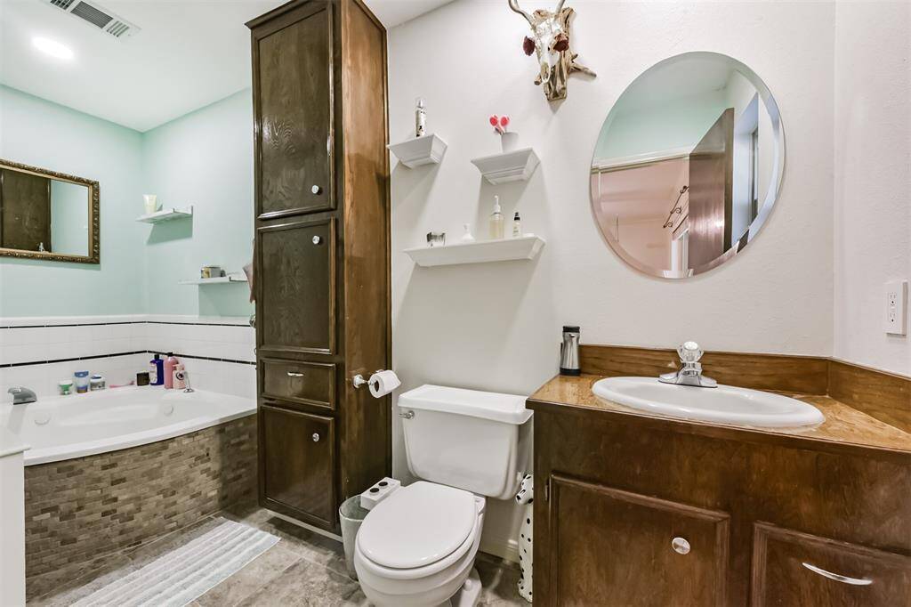Updated bath with jet tub, tile floors, and lots of cabinet space