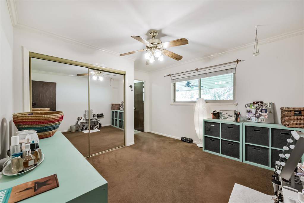 Bedroom with mirror sliding closet doors, ceiling fan with light and ensuite bath