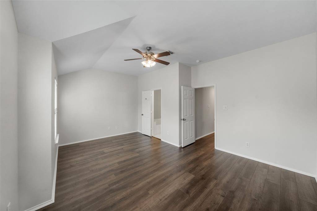 Another great view of the primary bedroom highlights the entrance to the luxurious primary bathroom, offering a seamless transition for ultimate comfort and privacy.