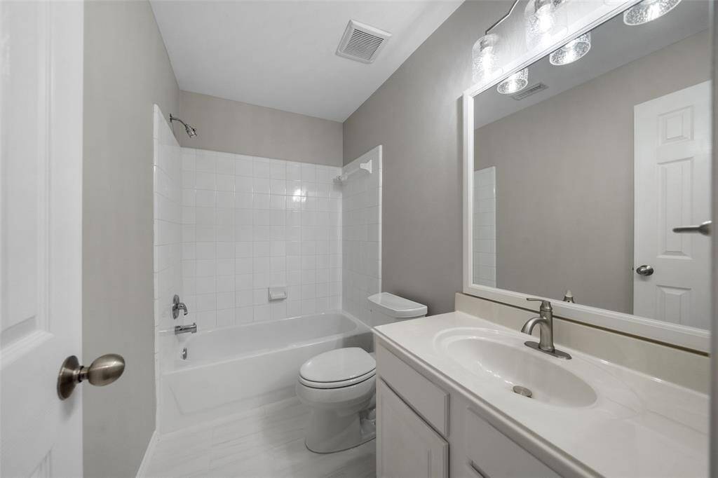 A view of the secondary bathroom, conveniently located off the secondary bedrooms, offering both functionality and easy access for family and guests.