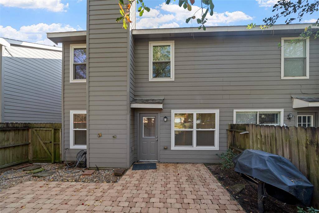 Another great view of the back patio, showcasing the charming exterior of the home and the serene surroundings for a peaceful retreat.