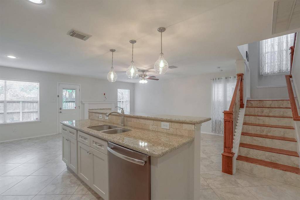 Another exceptional view of the kitchen showcases its abundant natural light, enhanced by thoughtfully placed lighting that creates a bright and welcoming atmosphere.