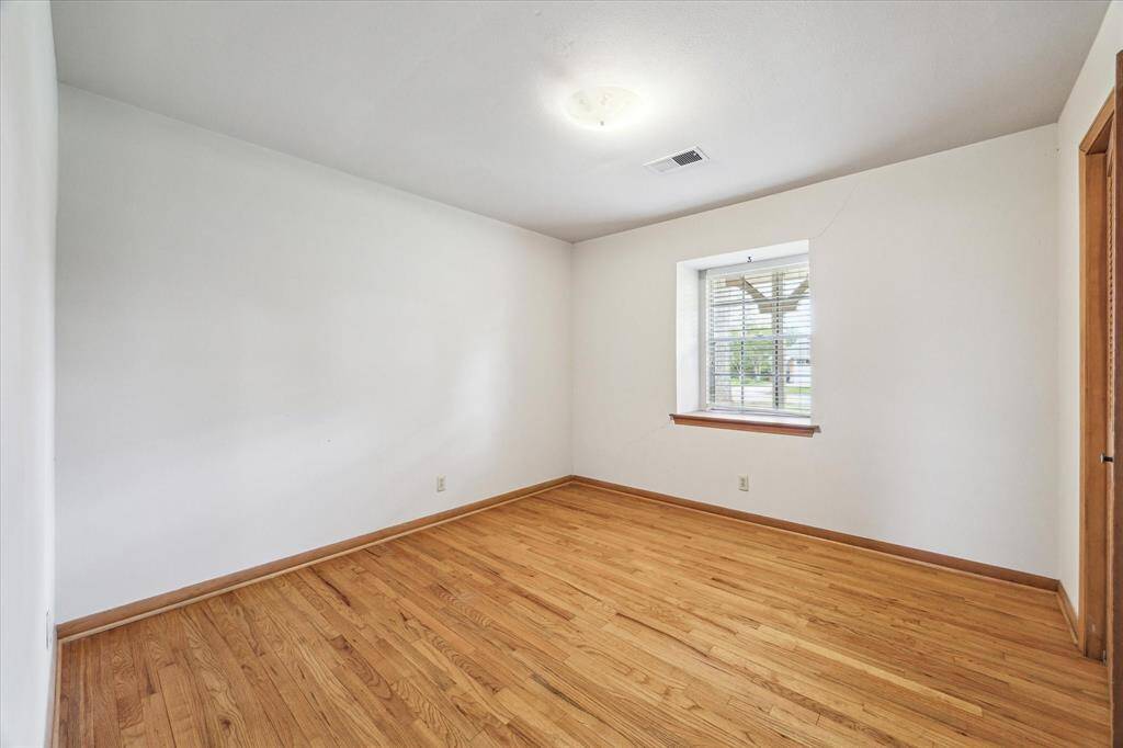 Bedroom 3 faces the front with morning sun. Hardwood floors in all bedrooms.