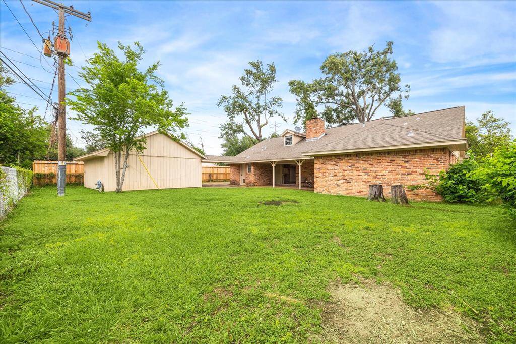 View of the backyard, covered patio and detached 2 car garage.  Originally designed as a 1 1/2 story the attic space provides the opportunity to raise the ceiling height in the den and living room.