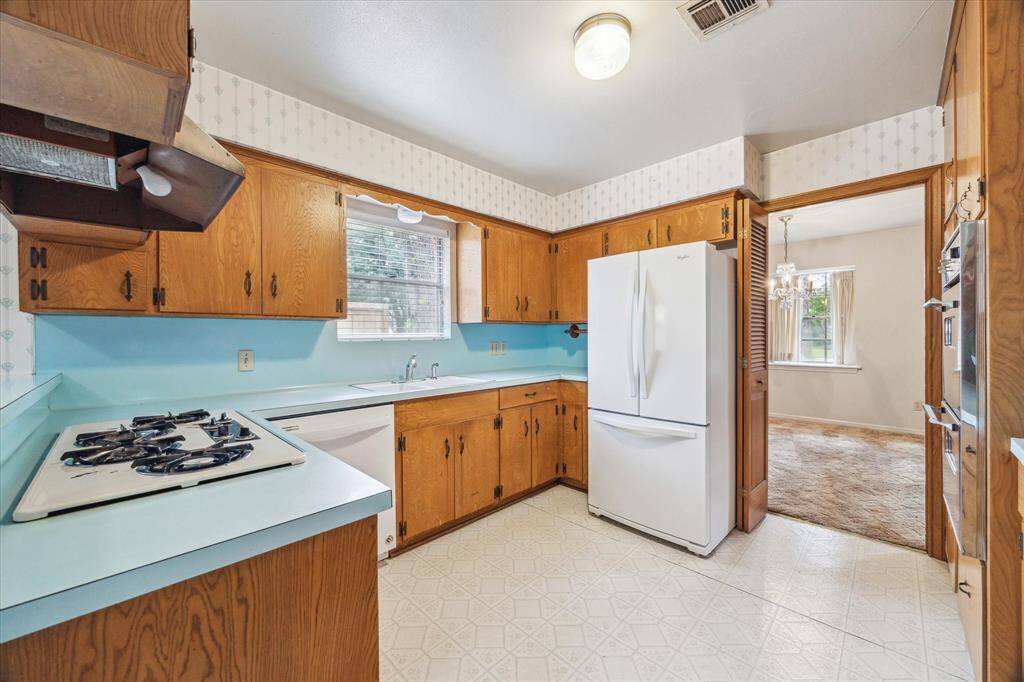 Vintage kitchen with gas cooktop.