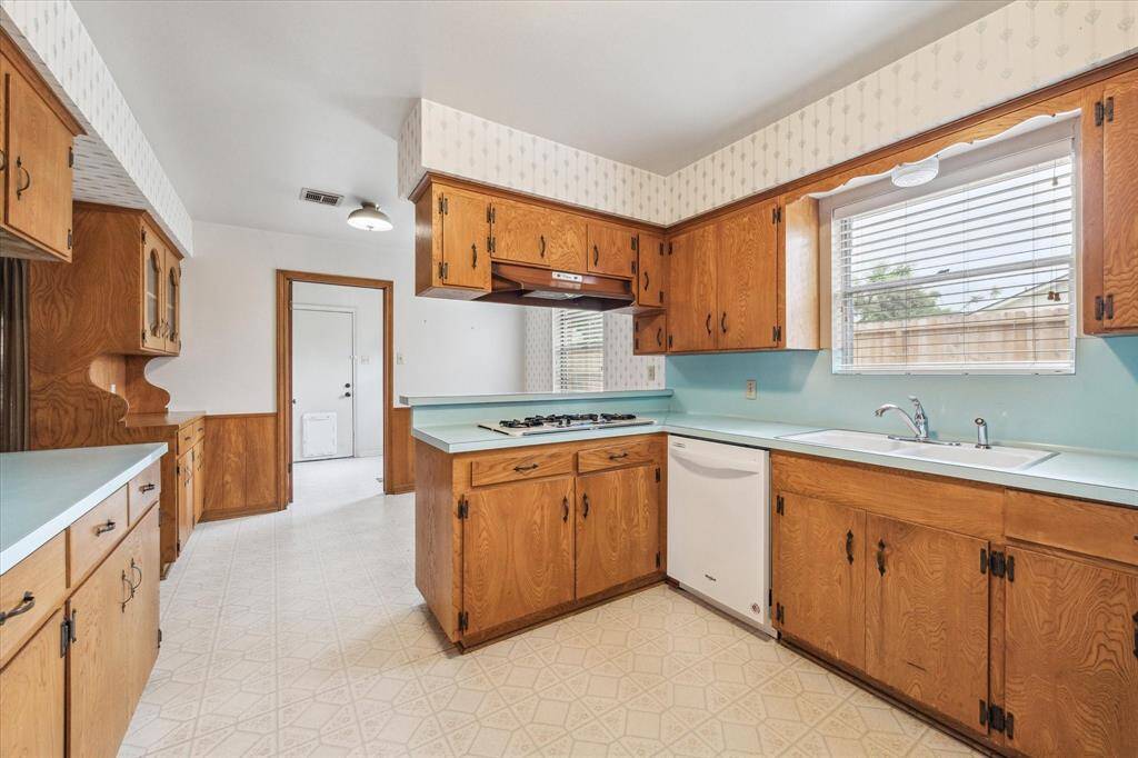 Another view of the sizable kitchen with breakfast area and built in hutch.  The laundry/mud room is just past the breakfast area for access to the backyard and garage.