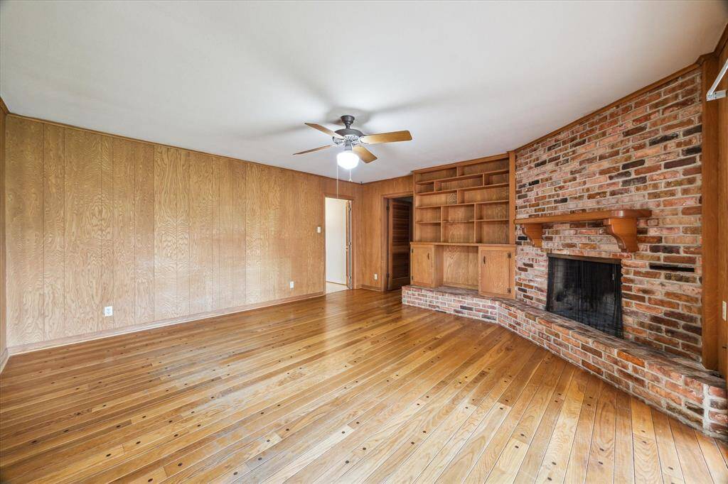 Another view of the spacious den with gas fireplace and built-ins.