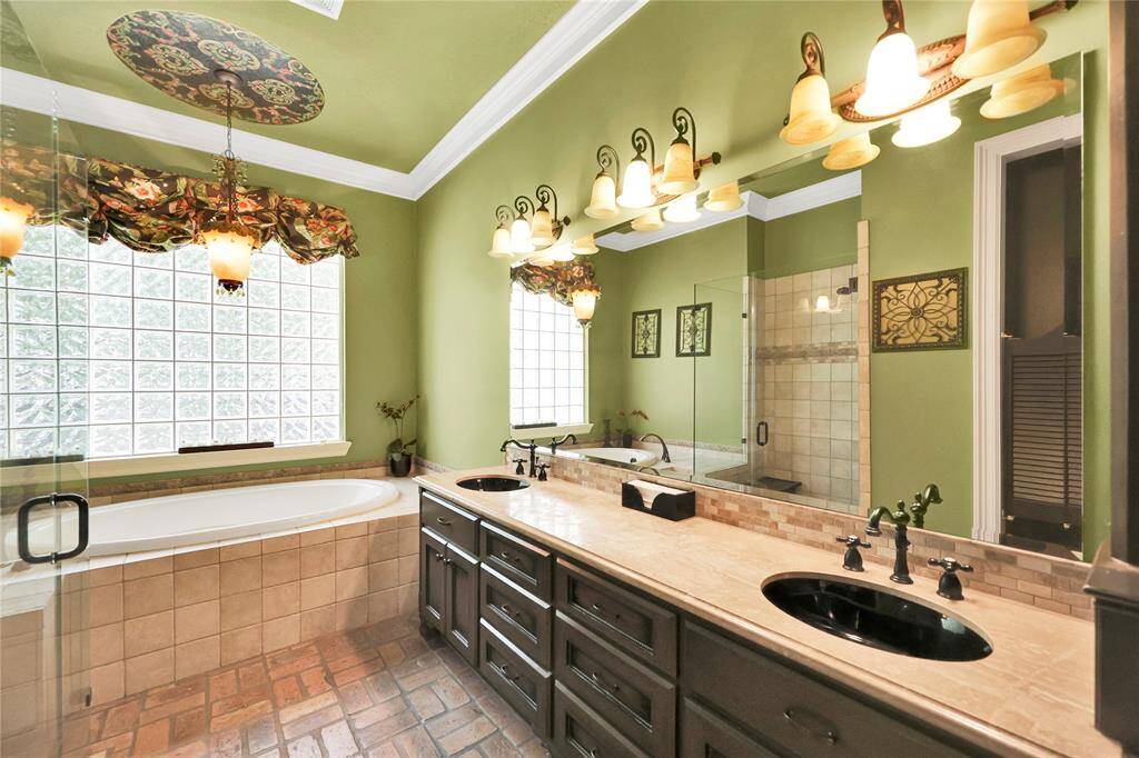 Bathroom shared by the front 2 bedrooms. Soaker tub and walk-in shower