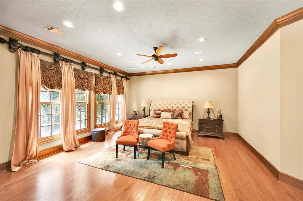 Spacious primary suit with gorgeous wood floors, located in the back of the home