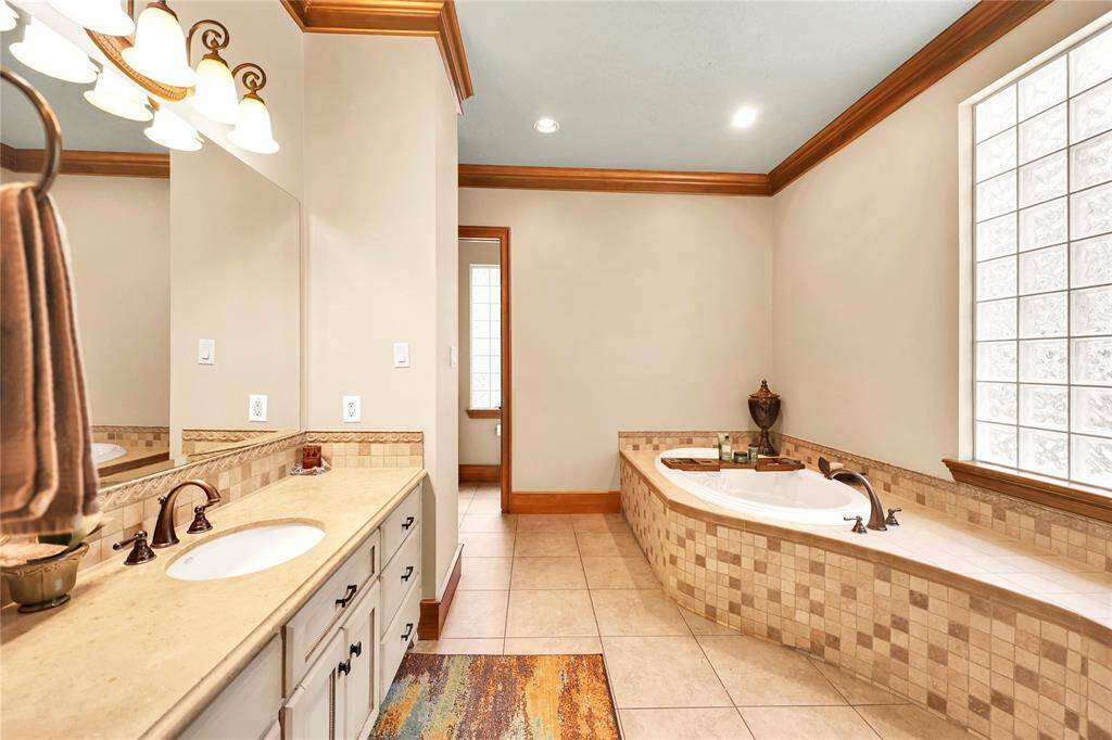 Primary suit has his & her vanity. Custom build in drawers to help keep you organized and clutter free.