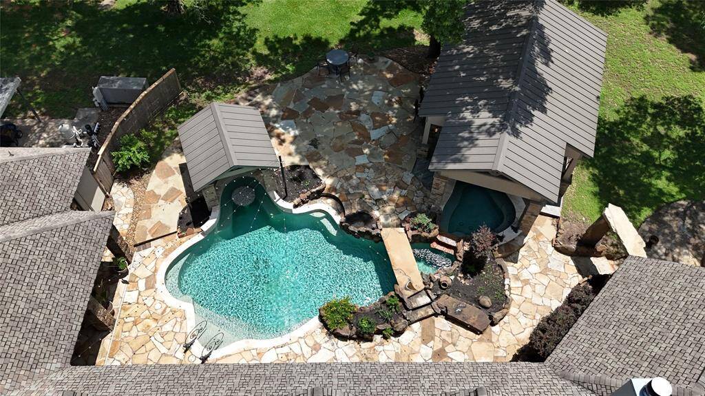 Backyard goals! Vaulted ceiling, stone fireplace, built-in grill, and plenty of seating. This outdoor space has it all!