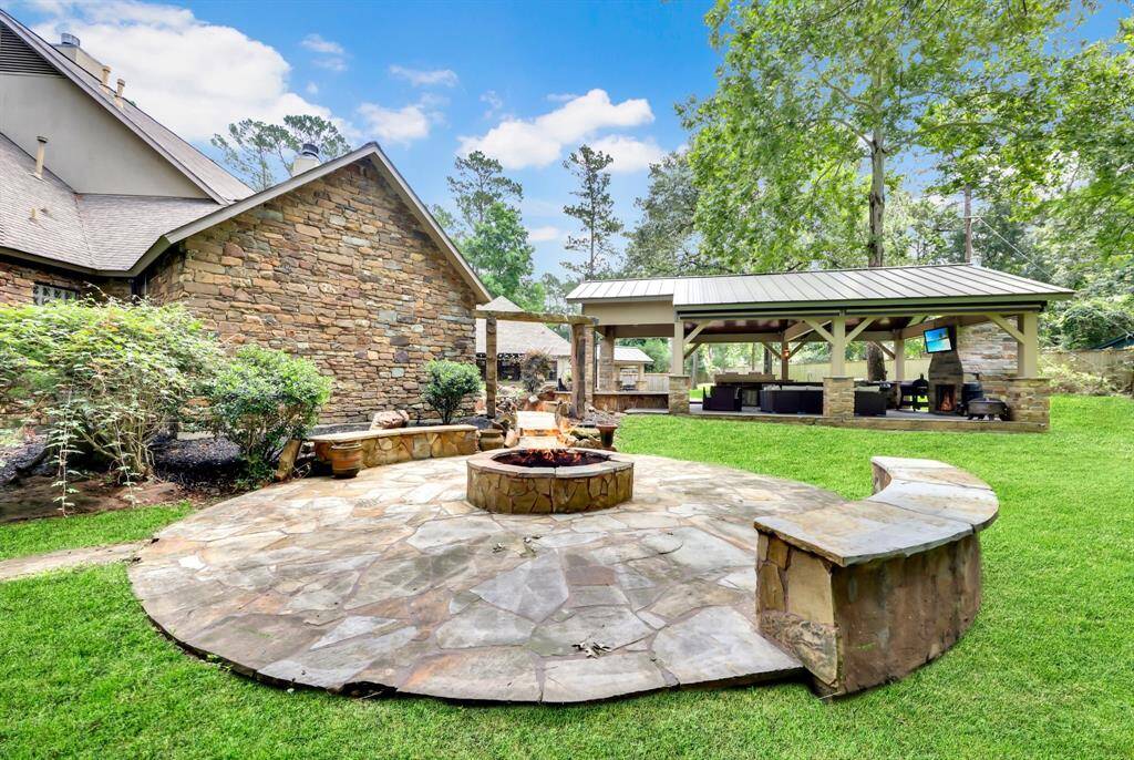 S'mores, stories, and starry nights! This backyard hangout comes complete with custom firepit, with built in stone seating.