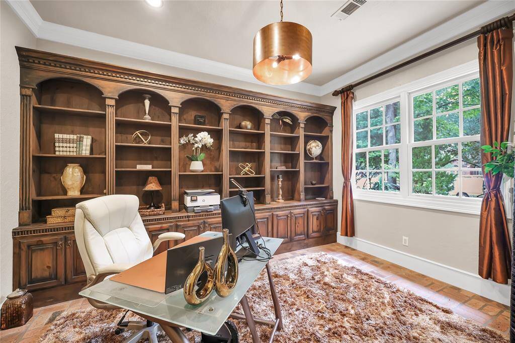Office right off the entry way has custom build in shelves.