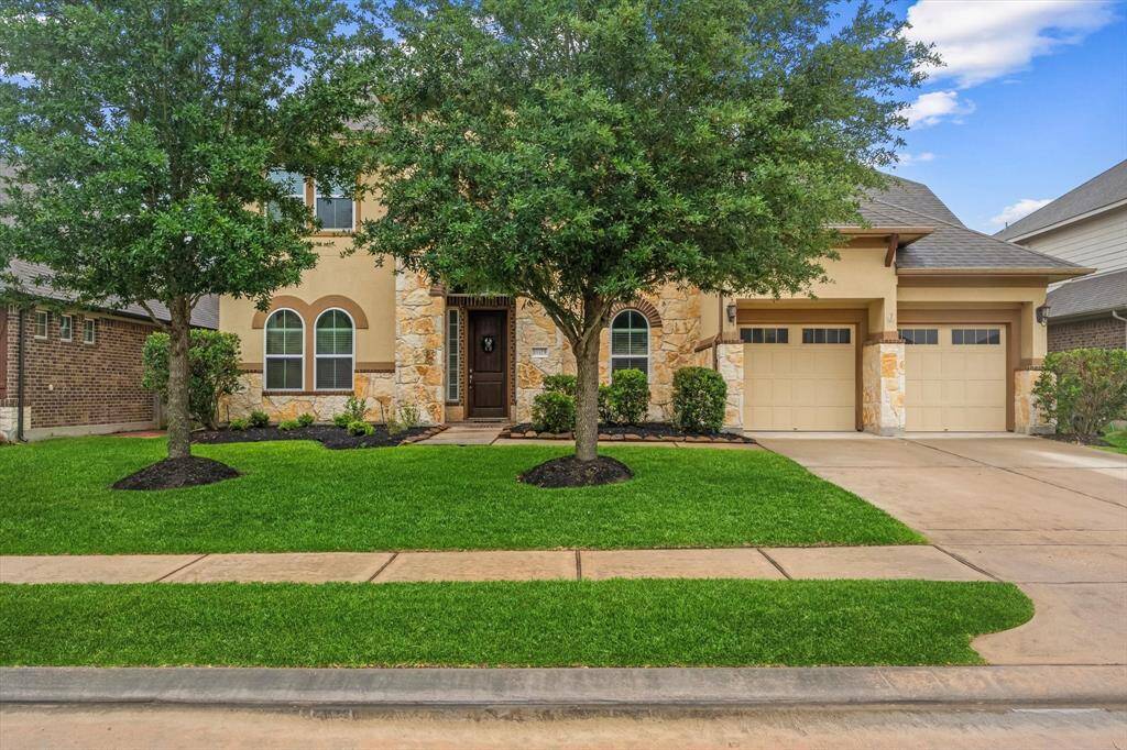 Oak trees shade the front of the home
