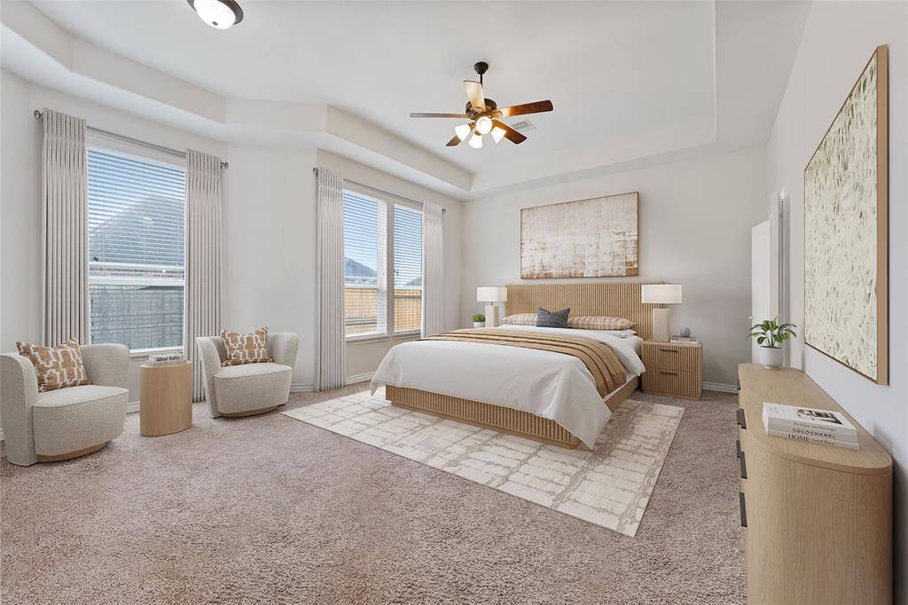 Primary suite with high ceiling and views to the backyard. Virtually Staged.