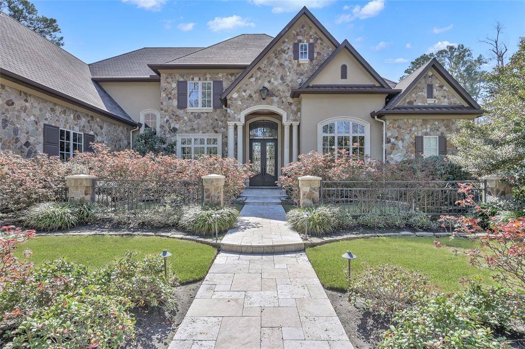 A beautiful stucco and stone elevation framed by professionally designed landscaping.