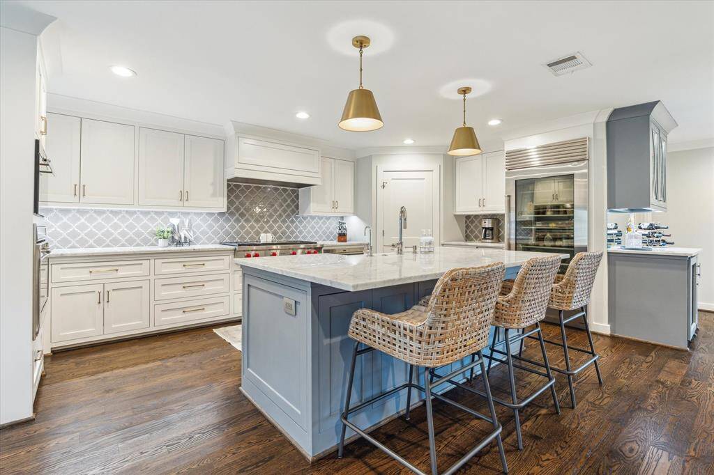 Gourmet kitchen equipped with a 48" Wolf Gas Oven, steam convection oven, and a Subzero refrigerator.