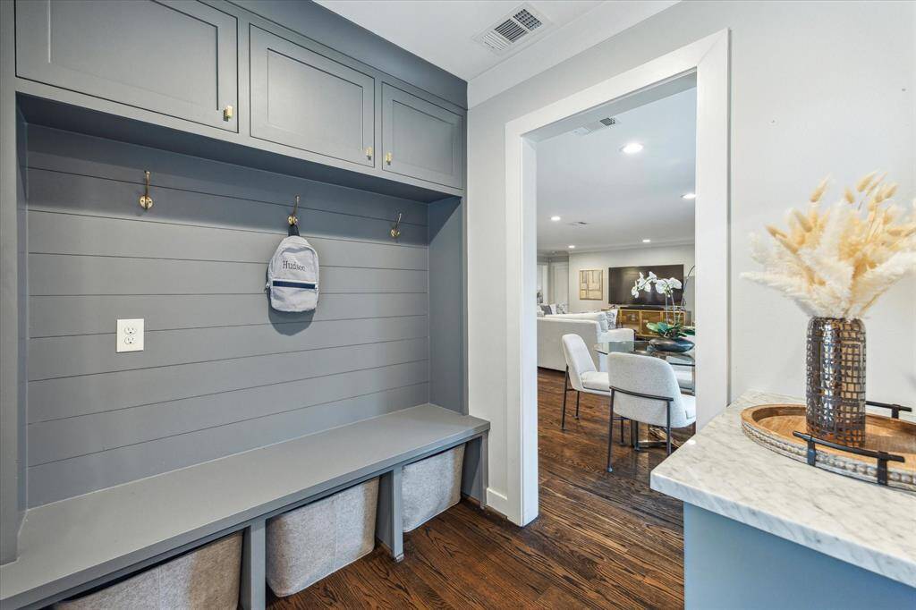 Adorable mud room with bench and storage for all your shoes and backpacks!