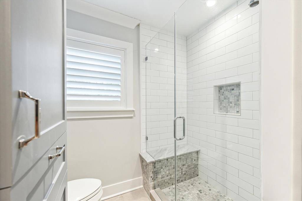 Large walk in shower with bench in 2nd floor bathroom.