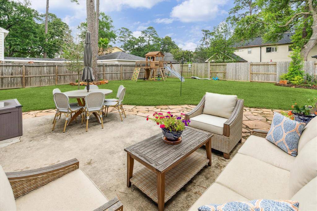 Beautifully landscaped yard and patio. There's additional yard space to the right that's not pictured. Lot is 10, 260 sq fot. Plenty of room for a pool!