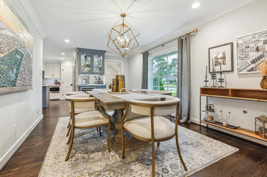 Stunning dining room with custom crown molding and big picture window makes this a lovely spot to have dinner with friends and family.
