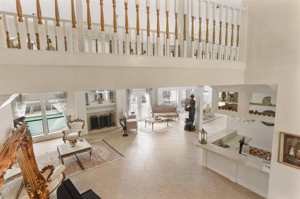 Plenty of natural light coming into this formal living area with custom mirror on one wall.