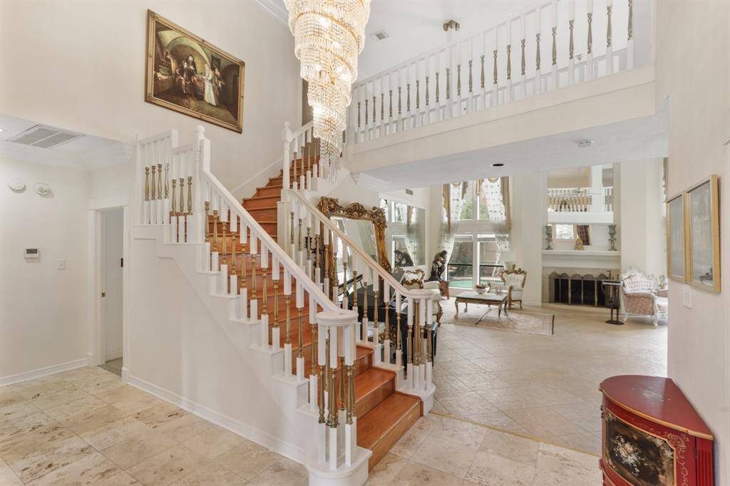 Looking from half way up the front stairs you see the grandeur of this living area.