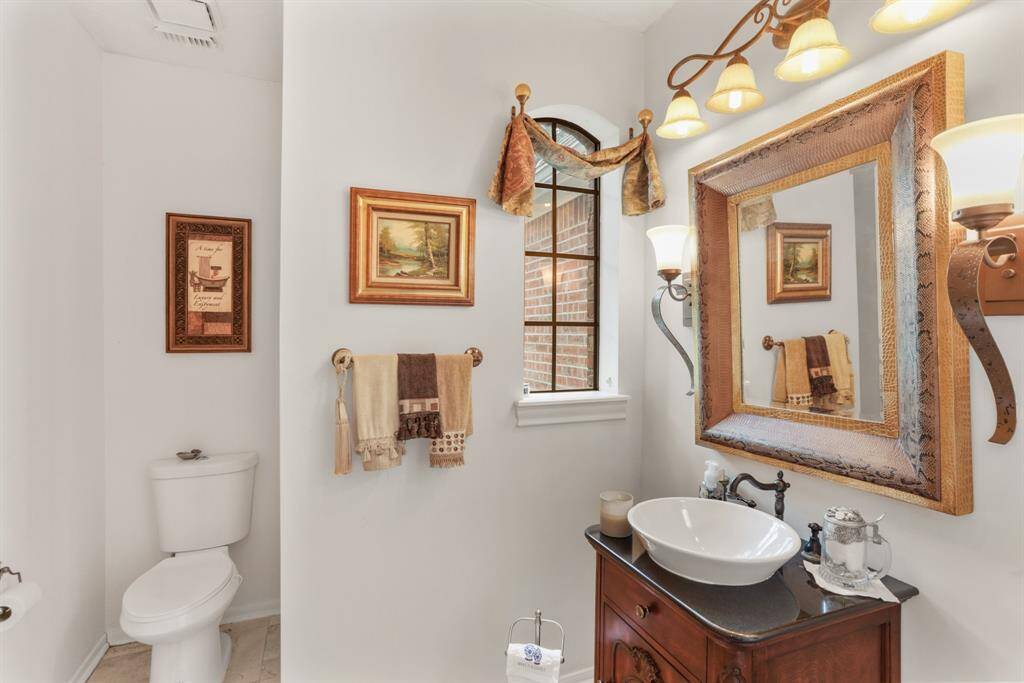 All wood study featuring wall of custom bookshelves, chandelier, crown molding and all wood floors.  There is a large closet so if needed can convert to 2nd bedroom down.