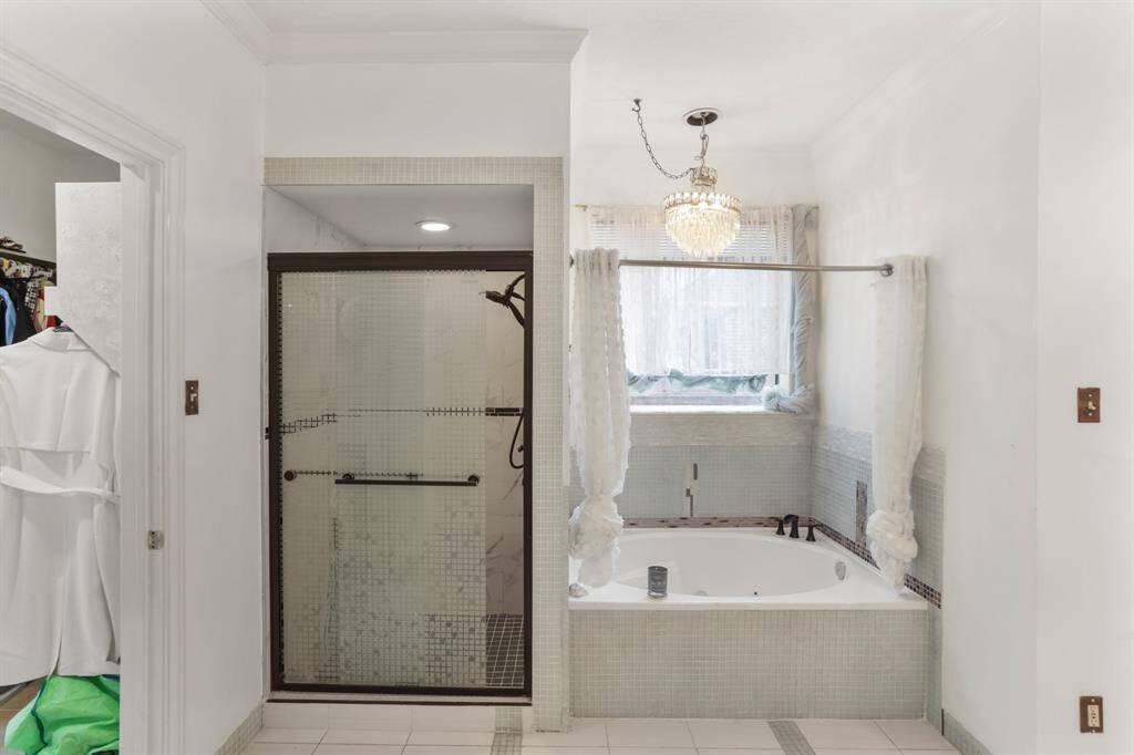 Custom Primary bathroom that is connected to the Primary Bedroom offering double sinks, vanity area, stone counter tops and his/her walk-in closets.